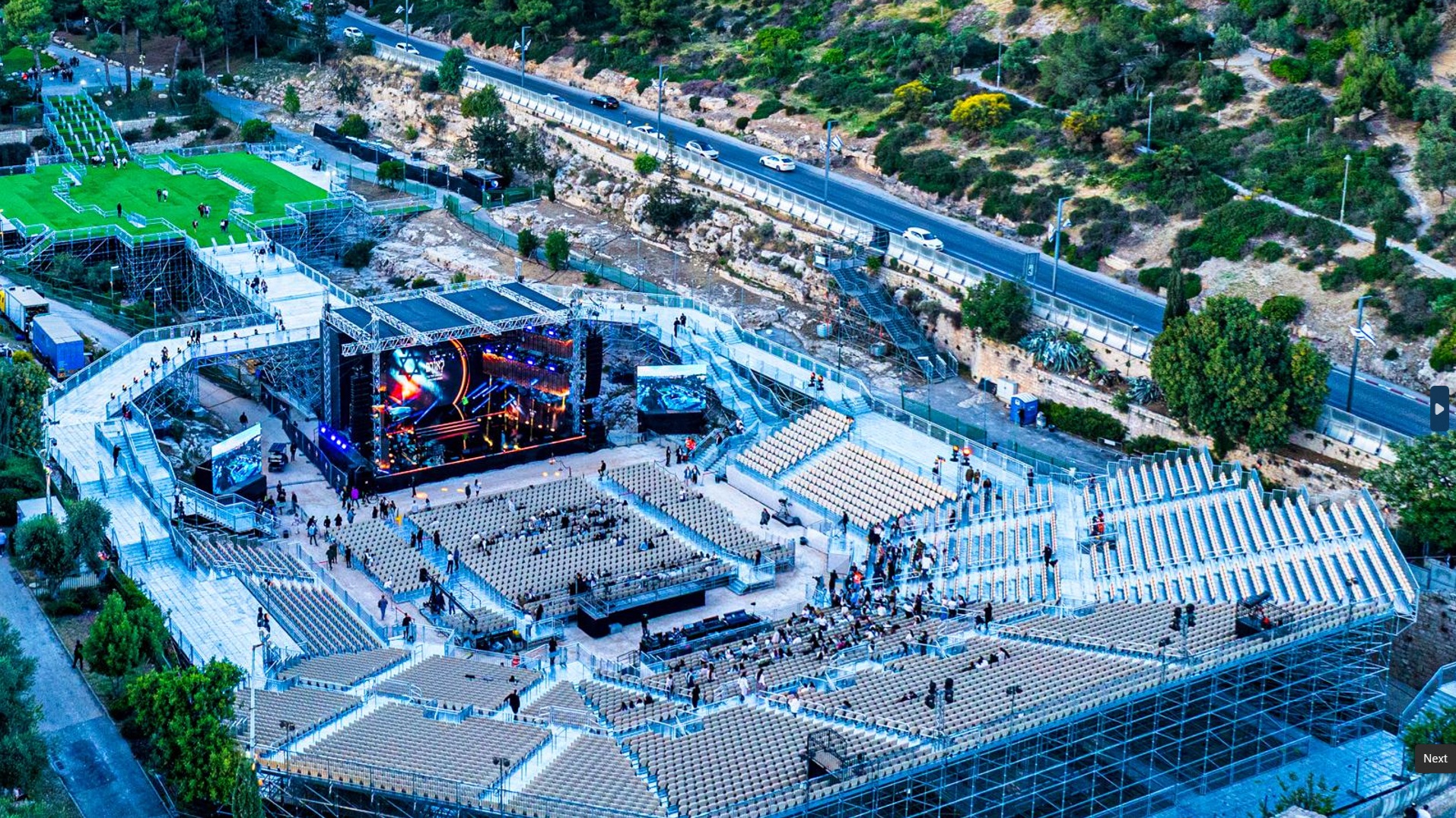 Wide shot of a modern stadium with grandstands.